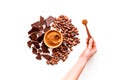 Make chocolate. Cocoa powder in bowl near cocoa beans and pieces of chocolate on white background top view copy space Royalty Free Stock Photo