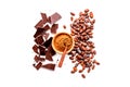 Make chocolate. Cocoa powder in bowl near cocoa beans and pieces of chocolate on white background top view copy space Royalty Free Stock Photo