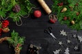 Make a Christmas wreath with your own hands. Spruce branch, Christmas wreath and gifts on a black wooden background Royalty Free Stock Photo