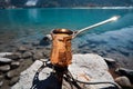 Make coffe with Copper Cezve in autumn lake camping in the mountains