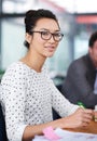 Make creativity a job. a young office worker sitting at her workstation in an office. Royalty Free Stock Photo