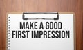 Make a good first impression text on white paper on the wood table Royalty Free Stock Photo