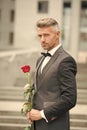 Make good first impression. Valentines day and anniversary. Handsome guy rose flower romantic date. Well groomed macho Royalty Free Stock Photo