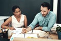 They make a great team together. two young architects working together in a modern office. Royalty Free Stock Photo