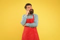 Make healthy decisions when ordering food at restaurant. Hipster in apron thinking about recipes. Easy to cook recipes Royalty Free Stock Photo