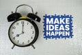 Make Ideas Happen text with alarm clock on navy blue background Royalty Free Stock Photo