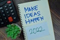 Make Ideas Happen 2022 write on a book isolated on Wooden Table