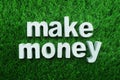 Make Money made from concrete alphabet on green grass Royalty Free Stock Photo