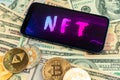 Make money with NFT non fungible token. Future of crypto art and crypto currency. Golden coin on dollar bills background