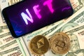 Make money with NFT non fungible token. Future of crypto art and crypto currency. Golden coin on dollar bills background