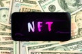 Make money with NFT non fungible token. Future of crypto art and crypto currency. Dollar bills background top view photo