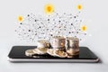 Make money online,  business e- commerce concept with stack of coin on mobile phone with technology background Royalty Free Stock Photo