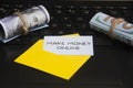 Make money online text on notepad in an envelope with laptop and bank notes background. Royalty Free Stock Photo