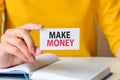 Make money written on a paper card in woman hand, concept Royalty Free Stock Photo