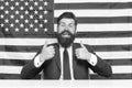Make our land the absolute best country. Happy hipster give thumbs ups. USA flag background. Bearded man gesturing Royalty Free Stock Photo