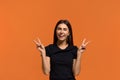 Make peace not war. Portrait of happy caucasian woman in black t-shirt, does victory sign, believes in winning, rejoices success.