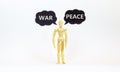 Make peace not war symbol. Concept words Peace and War. Wooden model of businessman human. Black paper. Beautiful white table Royalty Free Stock Photo