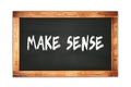 MAKE SENSE text written on wooden frame school blackboard