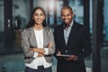 We make such a formidable team. Portrait of two young businesspeople standing together in an office. Royalty Free Stock Photo