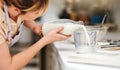 Make sure you get the correct measurements. a young woman measuring milk while baking at home.