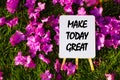 Make today great On background of pink flowers and green grass. Royalty Free Stock Photo