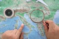 Make a travel plan by studying the map of Europe with a magnifying glass in hand Royalty Free Stock Photo