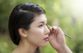 Make-up artist applying bright base color eyeshadow Royalty Free Stock Photo