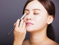 Make up artist applying color eyeshadow on model's eye Royalty Free Stock Photo
