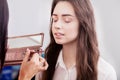 Make up artist applying eye shadow to a woman Royalty Free Stock Photo
