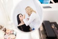 Make up artist applying eye shadow to a woman Royalty Free Stock Photo