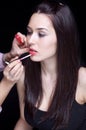Make-up artist applying gloss on lips Royalty Free Stock Photo