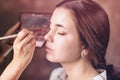 Make-up artist applying makeup to a client in a beauty salon Royalty Free Stock Photo