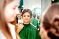 Make-up artist doing makeup for young beautiful bride applying wedding makeup in a beauty salon. Royalty Free Stock Photo