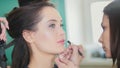 Make up artist doing professional make-up lips