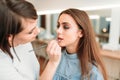 Make up artist hand applying gloss on woman lips Royalty Free Stock Photo