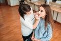 Make up artist hand applying gloss on woman lips Royalty Free Stock Photo