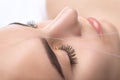 The make-up artist plucks eyebrows with a thread close-up. Women`s cosmetology in the beauty salon