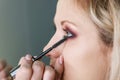 Make up artist working in make up studio, applying makeup Royalty Free Stock Photo