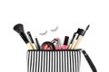 Make up bag with various cosmetics and brushes isolated