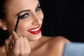 Make-up. Beautiful Woman Doing Makeup. Eyebrow Pencil. Red Lips Royalty Free Stock Photo