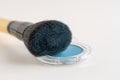 Make-up brush with blue eyeshadows Royalty Free Stock Photo