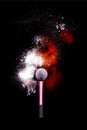 Make-up brush with colorful powder on black background. Explosion stars dust with bright colors. White and green powder red Royalty Free Stock Photo