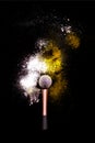 Make-up brush with colorful powder on black background. Explosion stars dust with bright colors. White and yellow powder. Royalty Free Stock Photo