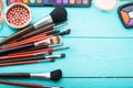 Make up brush and products. Copy space. Mock up. Cosmetics and accessories on blue wooden background. Top view