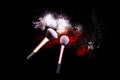 Make-up brush with white powder spilled glitter dust on black background. Makeup brush on new year`s Party with bright colors. Royalty Free Stock Photo