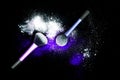 Make-up brush with white powder spilled glitter dust on black background. Makeup brush on new year`s Party with bright colors. Royalty Free Stock Photo