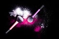 Make-up brush with white powder spilled glitter dust on black background. Makeup brush on new year`s Party with bright colors. Royalty Free Stock Photo