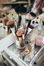 Make-up brushes and cosmetic on dressing table Royalty Free Stock Photo