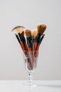 Make up brushes in glass on bright background. Beauty bar concept. Beauty shop, magazine, social media. Copyspace