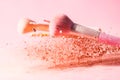 Make up brushes with powder splashes isolated on pink background Royalty Free Stock Photo